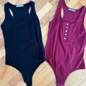 2 Women’s Black and Burgundy One-Piece Bodysuits